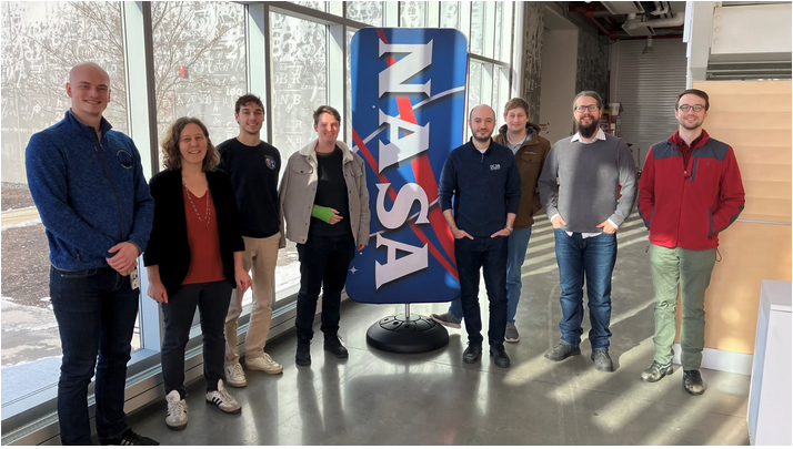 The Real Time Optical Receiver (RealTOR) team poses for a group photo in the Aerospace Communications Facility at NASA’s Glenn Research Center in Cleveland on Friday, Dec. 13, 2024. From left to right: Peter Simon, Sarah Tedder, John Clapham, Elisa Jager, Yousef Chahine, Michael Marsden, Brian Vyhnalek, and Nathan Wilson. Credit: NASA image