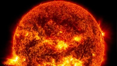 This image shows the bright light of a solar flare on the left side of the Sun and an eruption of solar material shooting through the Sun's atmosphere, called a prominence eruption. Credit: NASA/Goddard/SDO